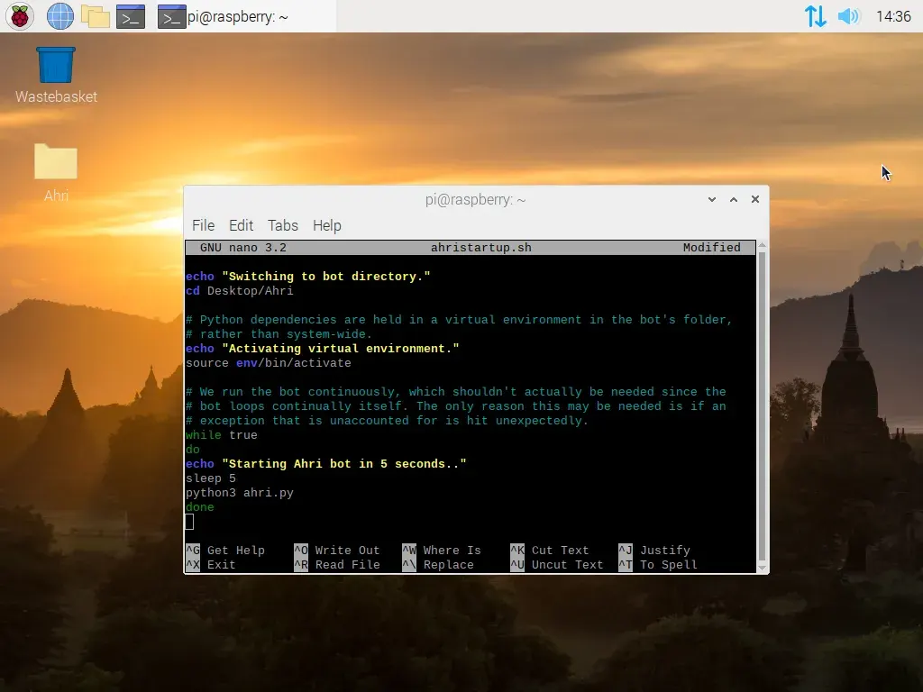 A screenshot of Raspberry Pi OS. A terminal window is open, which is running GNU nano with a bash script open named ahri startup dot sh. In the script, the commands read: echo switching to bot directory. cd desktop slash ahri. echo activating virtual environment. source env slash bin slash activate. while true, do echo starting ahri bot in 5 seconds. sleep 5. python 3 ahri dot py. done.