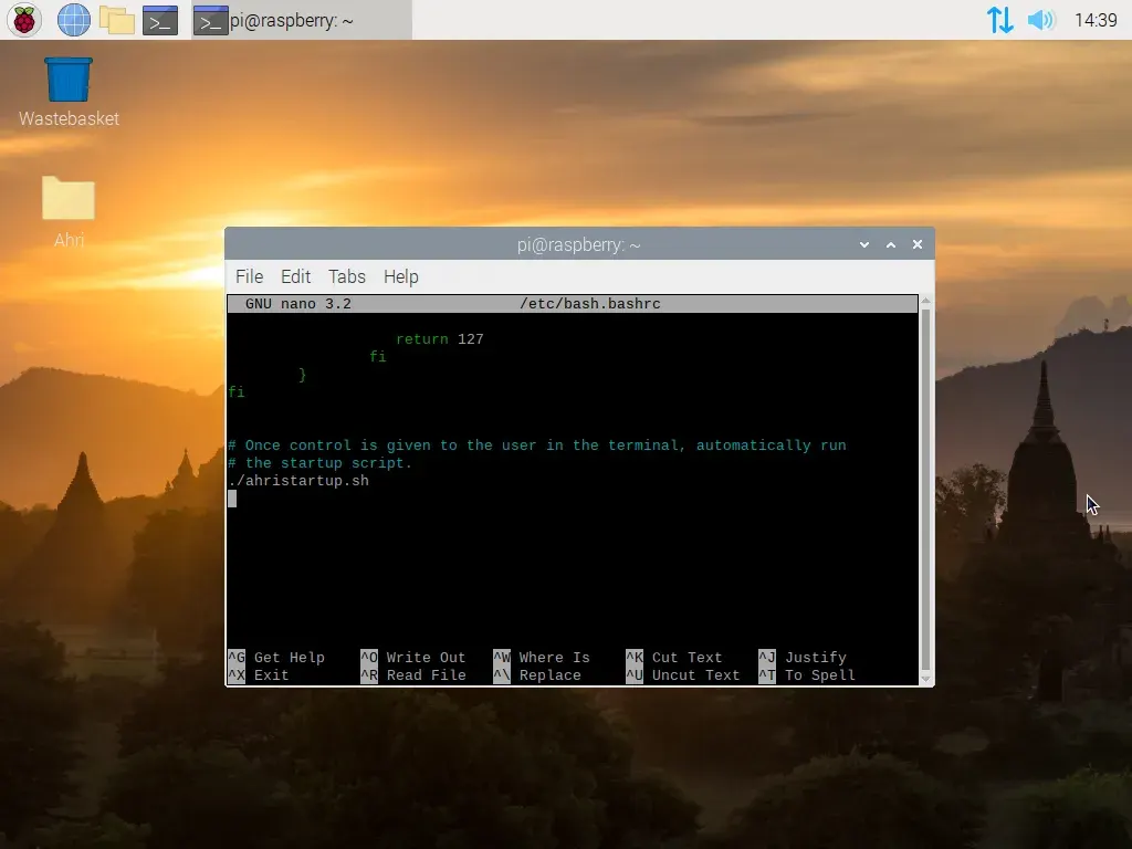 A screenshot of Raspberry Pi OS. A terminal window is open, and is running GNU nano in the directory etc slash bash dot bash rc. At the end of the file, a call is made to run the ahri startup dot sh script.